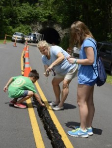 Visitors examine the Parkway crack near Tanbark Tunnerl this summer.